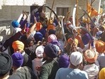 Supporters of Waris Punjab De chief Amritpal Singh clashing with Punjab Police personnel on Thursday afternoon as they headed for the police station in Ajnala to protest the arrest of his aide in a kidnap and assault case, Amritsar. (Sameer Sehgal /HT photo)
