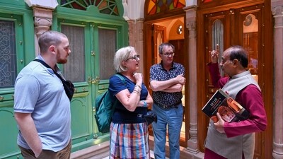 Vijay Goel (on the right), a politician and former member of parliament is seen talking to foreign tourists inside the Golden Haveli. “This haveli is more colourful and golden colour has been used a lot, so we decided to call it Golden Haveli. We have retained the original aesthetics and elements of the haveli in line with conservation principles. The jaalis and pillars are original. The Haveli has coloured glass panels. Wherever the glass panels were damaged, we replaced them with new ones,” said Goel in an exclusive interview with HT. (Sanchit Khanna/ HT Photo) Vijay Goel (on the right), a politician and former member of parliament is seen talking to foreign tourists inside the Golden Haveli. “This haveli is more colourful and golden colour has been used a lot, so we decided to call it Golden Haveli. We have retained the original aesthetics and elements of the haveli in line with conservation principles. The jaalis and pillars are original. The Haveli has coloured glass panels. Wherever the glass panels were damaged, we replaced them with new ones,” said Goel in an exclusive interview with HT. (Sanchit Khanna/ HT Photo)
