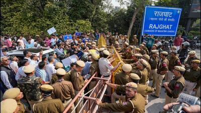 Delhi Police barricades to stop the AAP supporters during Delhi Deputy Chief Minister Manish Sisodia's visit to Rajghat ahead of his questioning by CBI in the liquor policy case, in New Delhi on Sunday. (PTI) Delhi Police barricades to stop the AAP supporters during Delhi Deputy Chief Minister Manish Sisodia's visit to Rajghat ahead of his questioning by CBI in the liquor policy case, in New Delhi on Sunday. (PTI)