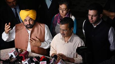 Delhi chief minister Arvind Kejriwal and Punjab chief minister Bhagwant Mann address media persons outside Delhi deputy chief minister Manish Sisodia’s residence in New Delhi on Sunday. (Vipin Kumar/HT Photo)
