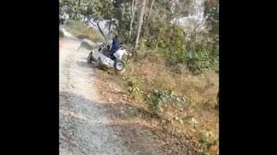 The image shows the moment before the safari vehicles topples while escaping two rhinos. (Twitter/@aakashbadhawan)