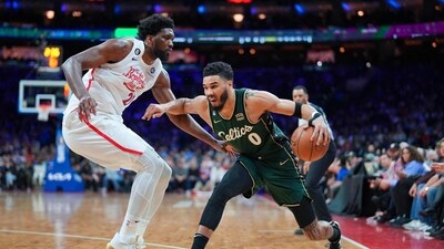 Jayson Tatum #0 of the Boston Celtics dribbles the ball against Joel Embiid #21 of the Philadelphia 76ers in the fourth quarter at the Wells Fargo Center. (Getty Images via AFP)