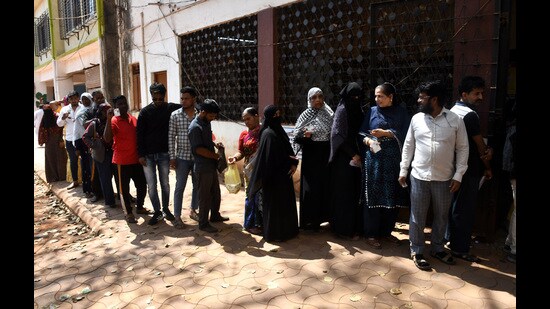 Residents line up to cast their ballots in Kasaba Peth constituency bypoll at Bhavani Peth on Sunday. (HT PHOTO)