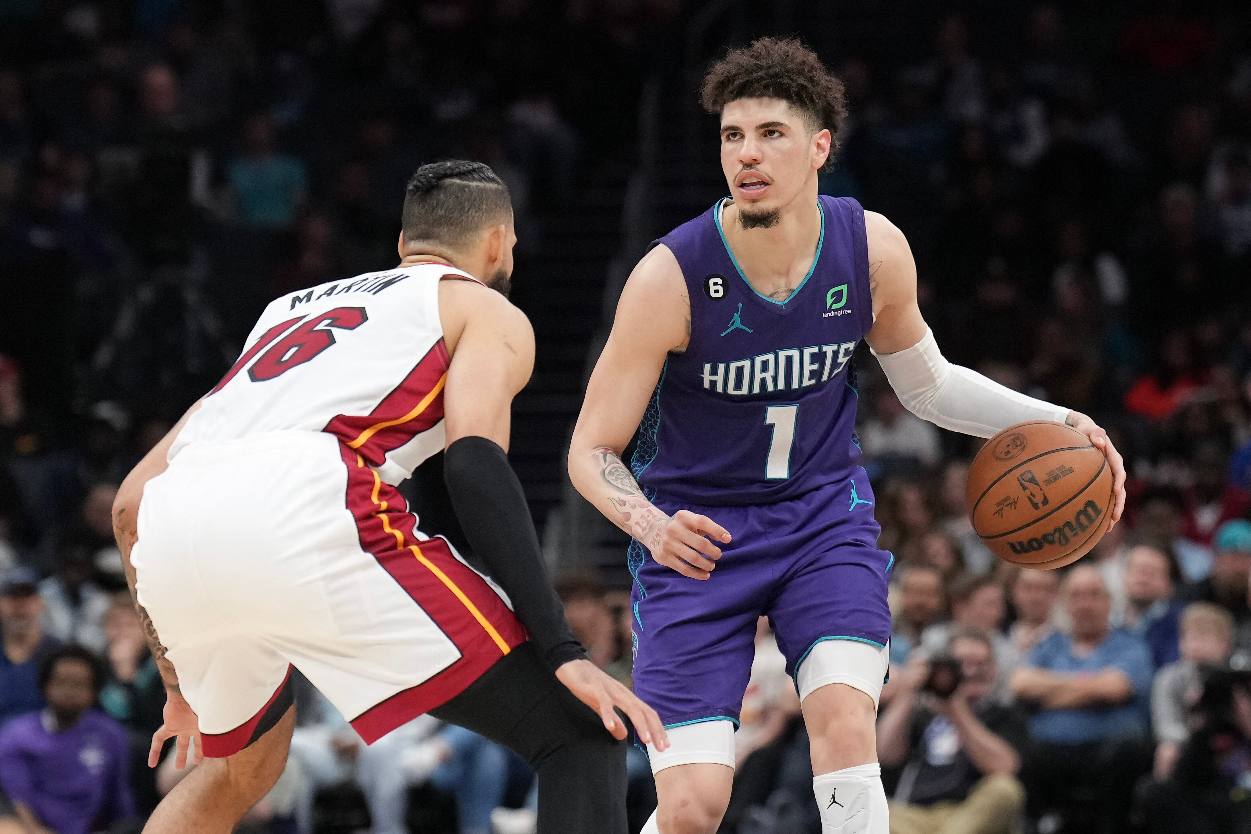 Miami Heat forward Caleb Martin (16) defends against Charlotte Hornets guard LaMelo Ball (1) in the second half at Spectrum Center. (USA TODAY Sports)