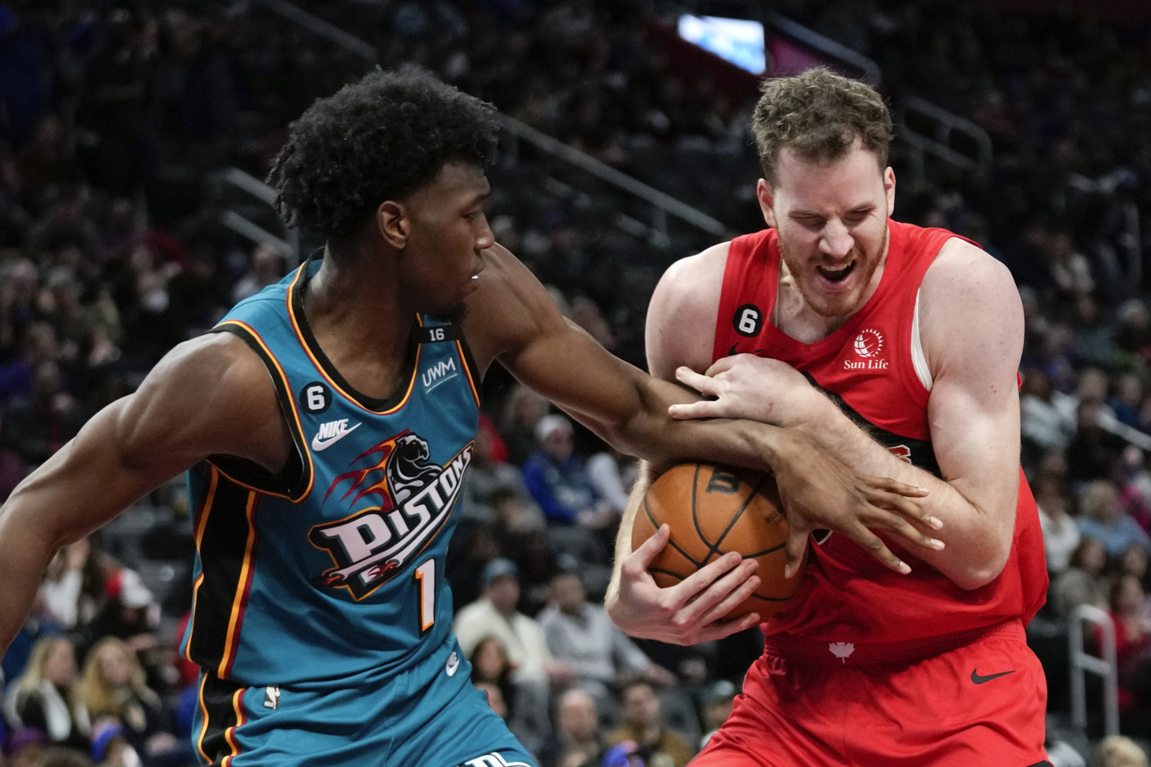 Detroit Pistons center James Wiseman, left, battles for a rebound with Toronto Raptors center Jakob Poeltl (19) in the first half of an NBA basketball game in Detroit. (AP)