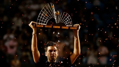 Cameron Norrie of the United Kingdom holds the trophy of the Rio Open Tennis tournament after defeating Spain's Carlos Alcaraz (AP) Cameron Norrie of the United Kingdom holds the trophy of the Rio Open Tennis tournament after defeating Spain's Carlos Alcaraz (AP)