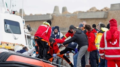 Bodies are moved from a coast guard boat in the aftermath of a deadly migrant shipwreck, at the port in Le Castella, Italy, February 27. (REUTERS)