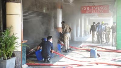 Firefighters working to douse the fire at the godown in Chandigarh’s Sector 26. (HT Photo)