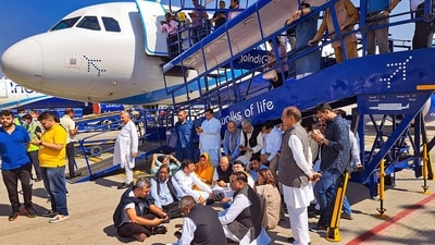 Congress leader Pawan Khera was taken away by police from the tarmac of Delhi airport after he was de-boarded from a Raipur-bound IndiGo flight on Thursday. (PTI) Congress leader Pawan Khera was taken away by police from the tarmac of Delhi airport after he was de-boarded from a Raipur-bound IndiGo flight on Thursday. (PTI)