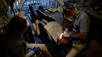 Hungarian dentist Ivan Solymosi checks British patient Bob Martin's implants at the Kreativ Dental Clinic in Budapest, Hungary, (REUTERS/Marton Monus) Hungarian dentist Ivan Solymosi checks British patient Bob Martin's implants at the Kreativ Dental Clinic in Budapest, Hungary, (REUTERS/Marton Monus)