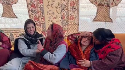 PDP chief Mehbooba Mufti with the bereaved family of a Kashmitri Pandit who was by terrorists in Pulwama on Sunday.