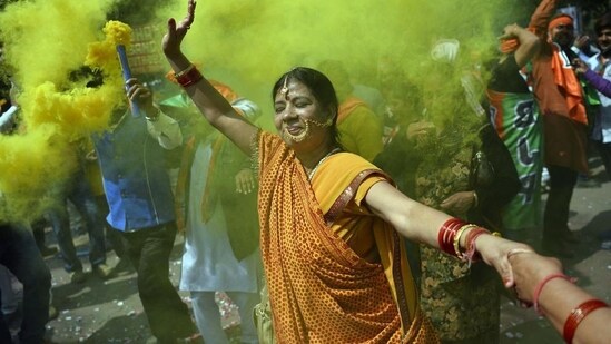 A BJP supporter outside the party headquarters in New Delhi after the results of the 2022 Municipal Corporation of Delhi elections were announced. (AFP)