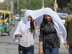 Girls use a scarf to cover their faces on a hot day, in Gurugram on February 27. (Parveen Kumar/ HT)