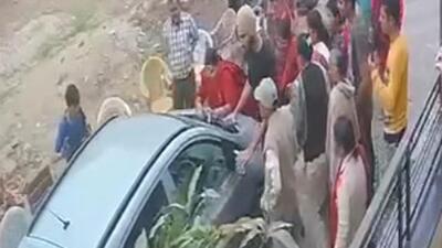 A CCTV grab showing the woman being dragged on car bonnet in Ekta Vihar Colony of Baltana on Tuesday. (HT Photo)