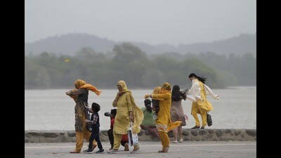 Visitors brave dust at Sukhna Lake in Chandigarh on Tuesday. (Ravi Kumar/HT)