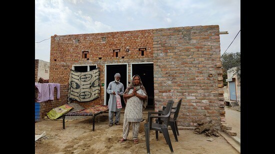 Daily wage earner Sukhchain Singh’s parents Kirpal Kaur and Najar Singh outside their partially constructed house at Bhana village in Faridkot district. (HT Photo)