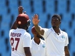 Cricket - First Test - South Africa v West Indies - SuperSport Park Cricket Stadium, Centurion, South Africa - March 1, 2023 West Indies' Alzarri Joseph celebrates with Raymon Reifer after taking the wicket of South Africa's Gerald Coetzee REUTERS/Siphiwe Sibeko