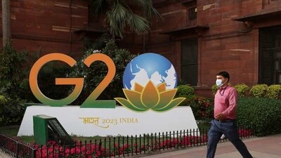 A man walks past a model of G20 logo outside the finance ministry in New Delhi on March 1 (REUTERS)