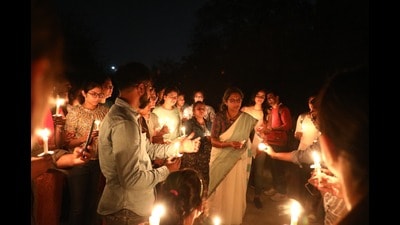 CDRI director Radha Rangarajan along with Insitute’s students during a candle walk on Wednesday (HT Photo)