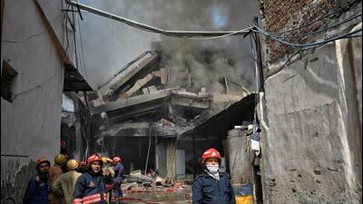 Firefighters had a narrow escape when the structure came crashing down. (Sanchit Khanna/HT Photo) Firefighters had a narrow escape when the structure came crashing down. (Sanchit Khanna/HT Photo)