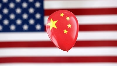 China Spy Balloon: A printed balloon with Chinese flag is placed on a US flag in this illustration. (Reuters)