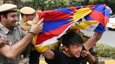 A protestor with Tibetan flag being shoved away by the police.&nbsp; (Vipin Kumar/ Hindustan Times)