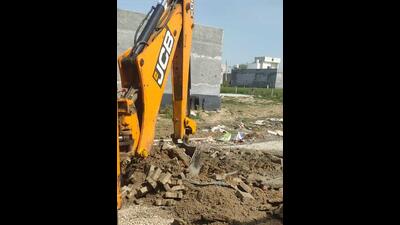 A JCB demolishing four illegal colonies on Ludhiana-Dhandra Road in Ludhiana on Thursday. (HT photo) A JCB demolishing four illegal colonies on Ludhiana-Dhandra Road in Ludhiana on Thursday. (HT photo)