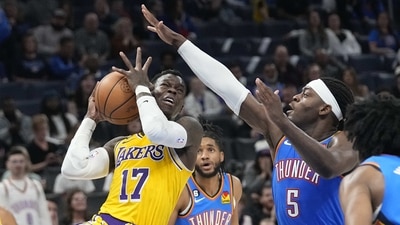 Los Angeles Lakers guard Dennis Schroder (17) drives to the basket past Oklahoma City Thunder guard Luguentz Dort (5) in the second half of an NBA basketball game. (AP) Los Angeles Lakers guard Dennis Schroder (17) drives to the basket past Oklahoma City Thunder guard Luguentz Dort (5) in the second half of an NBA basketball game. (AP)