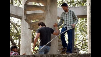 The man (in shirt), who had climbed atop a water tank at the mini-secretariat, being brought down by a friend in Ludhiana on Thursday. (Gurpreet Singh/HT photo) The man (in shirt), who had climbed atop a water tank at the mini-secretariat, being brought down by a friend in Ludhiana on Thursday. (Gurpreet Singh/HT photo)