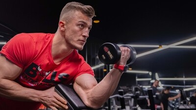 Spider Curl: This exercise is great for isolating your biceps. Start by sitting on a preacher curl bench with a pair of dumbbells in your hands. Keeping your elbows close to your body, curl the dumbbells up until your forearms touch your biceps. Slowly lower the dumbbells back to the starting position. (Unsplash)