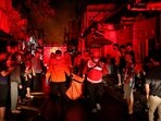 Rescuers carry a body bag of a victim after a fire at a fuel storage station operated by Indonesia's state energy company Pertamina, in Jakarta, Indonesia.