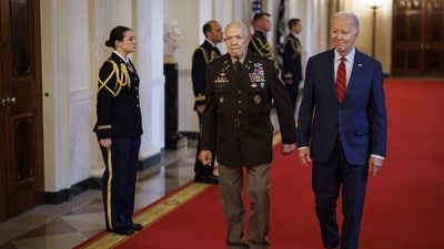 US President Joe Biden and Retired US Army Colonel Paris Davis arrive to a Medal of Honor ceremony in the East Room of the White House in Washington, DC, US. (Bloomberg)