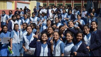 High school students celebrate after writing their final paper of the board exam, in Prayagraj on Friday. (HT )