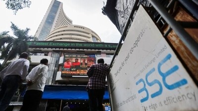 People stand outside the Bombay Stock Exchange (BSE), after Sensex surpassed the 60,000 level for the first time, in Mumbai, India (REUTERS)