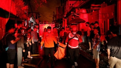 Rescuers carry a body bag of a victim after a fire at a fuel storage station operated by Indonesia's state energy company Pertamina, in Jakarta, Indonesia. (Reuters)