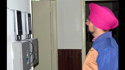 MC staff marking attendance through facial recognition machines installed in the MC offices in Ludhiana on Friday. (HT Photo)