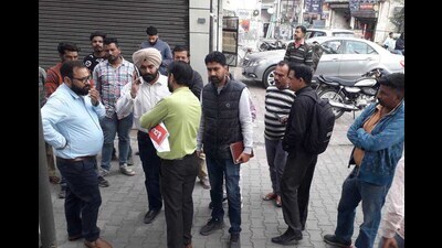 MC team members sealing a commercial property in zone B area of Ludhiana on Friday. (HT photo)