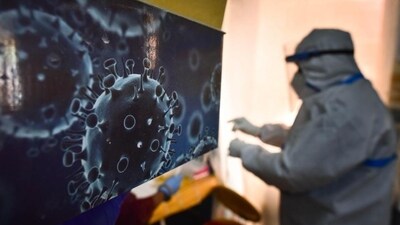 An illustration of the novel coronavirus seen next to a health care worker at a Covid-19 testing centre. (Sanchit Khanna / HT Photo) An illustration of the novel coronavirus seen next to a health care worker at a Covid-19 testing centre. (Sanchit Khanna / HT Photo)