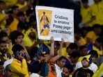 A fan carries a poster asking for the jersey of Cristiano Ronaldo during the Saudi Pro League football match between Al-Nassr and Al-Batin at the Mrsool Park Stadium A fan carries a poster asking for the jersey of Cristiano Ronaldo during the Saudi Pro League football match between Al-Nassr and Al-Batin at the Mrsool Park Stadium