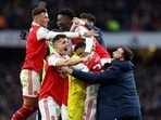 Reiss Nelson celebrates scoring Arsenal's third goal with teammates