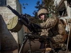 A Ukrainian serviceman fires an automatic grenade launcher, as Russia's attack on Ukraine continues, in the front line city of Bakhmut, in Donetsk region, Ukraine on Friday. 