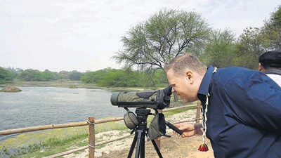 A delegate watches migratory birds at Sultanpur National Park on Saturday in Gurugram. (Sanjeev Verma/HT PHOTO) A delegate watches migratory birds at Sultanpur National Park on Saturday in Gurugram. (Sanjeev Verma/HT PHOTO)