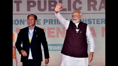 Dimapur, Feb 24 (ANI): Prime Minister Narendra Modi waves to the crowd as he arrives to address a public rally for the upcoming Nagaland Assembly elections, at Agri Expo, Chumukedima, in Dimapur on Friday. Nagaland Chief Minister Neiphiu Rio is also seen. (ANI Photo) (Caisii Mao)