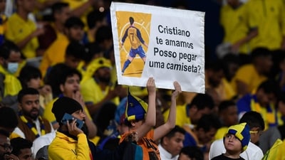 A fan carries a poster asking for the jersey of Cristiano Ronaldo during the Saudi Pro League football match between Al-Nassr and Al-Batin at the Mrsool Park Stadium (AFP) A fan carries a poster asking for the jersey of Cristiano Ronaldo during the Saudi Pro League football match between Al-Nassr and Al-Batin at the Mrsool Park Stadium (AFP)