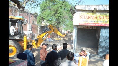 The demolition drive at the Sector-26 grain market was jointly carried out by the UT Estate Office, market committee and municipal corporation. (Ravi Kumar/HT)