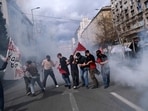 Demonstrators try to avoid tear gas thrown by riot police during clashes in Athens, Greece, Sunday, March 5, 2023. Thousands protesters, take part in rallies around the country for fifth day, protesting the conditions that led the deaths of dozens of people late Tuesday, in Greece's worst recorded rail accident. (AP Photo/Aggelos Barai)