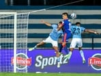 Mehtab Singh and Vignesh Dakshinamurthy of Mumbai City FC, Sunil Chhetri of Bengaluru FC in action during the league stage