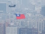 China-Taiwan Conflict: A Chinook helicopter carrying a Taiwan flag flies over the city during the country's National Day celebration in Taipei, Taiwan.