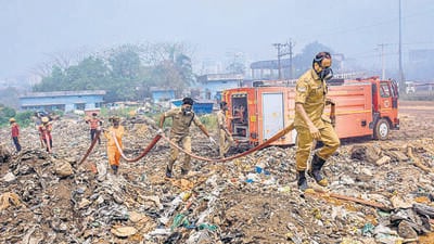 Fire fighters try to douse the fire that broke out at a solid waste dumping yard in Brahamapuram in Kochi. (PTI)