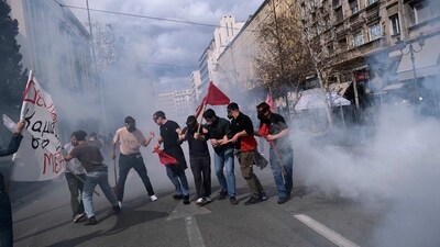 Demonstrators try to avoid tear gas thrown by riot police during clashes in Athens, Greece, Sunday, March 5, 2023. Thousands protesters, take part in rallies around the country for fifth day, protesting the conditions that led the deaths of dozens of people late Tuesday, in Greece's worst recorded rail accident. (AP Photo/Aggelos Barai) (AP)